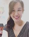 A photo of Yun-Wen Chan with medium, wavy hair and a black and white zigzag blouse