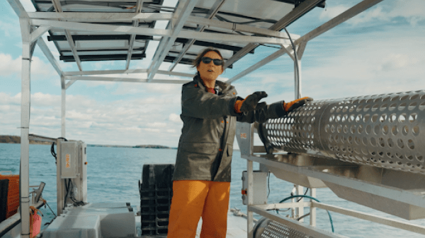 Alicia shows off the tumbler on their work barge