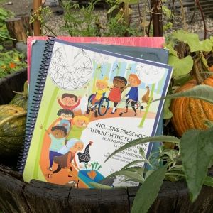 Picture of the book in a whiskey barrel with pumpkins around it