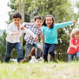 Kids racing up a grassy plain.