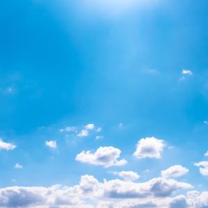 white clouds at horizon against blue sky