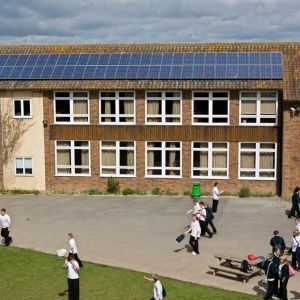 Solar PV panels on the roof above a playground. Photo credit: Andy Aitchinson / Ashden