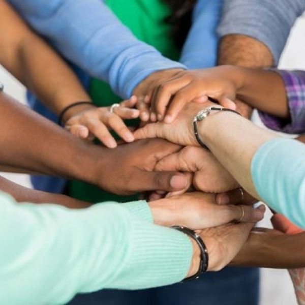 many hands together in solidarity