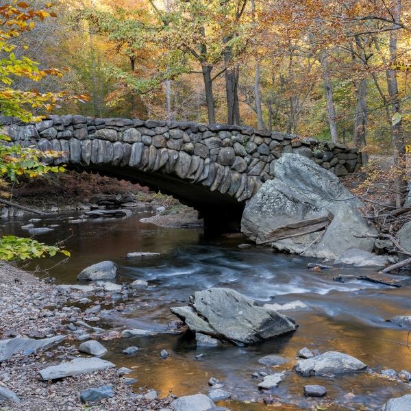 An autumn view of the Boulder Bridge in Rock Creek Park, Washington, DC.