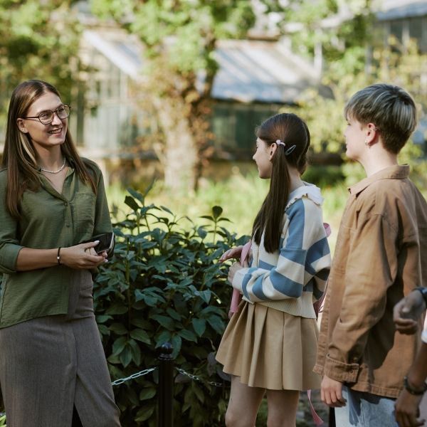 A teacher and three students outside